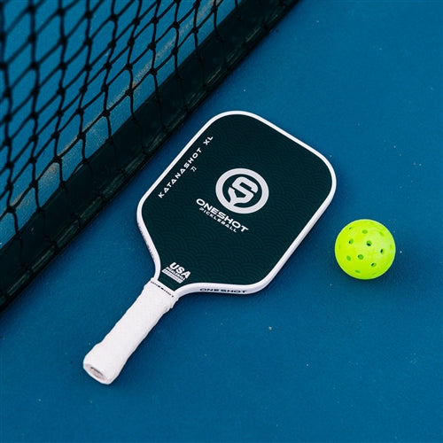 Katanashot XL Paddle by Oneshot Pickleball featuring a black carbon face and white logo, edge guard, and grip